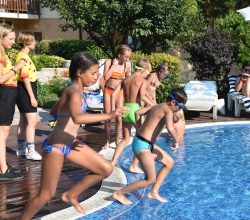 Деца скачат в басейна по време на дневна игра, водена от детски аниматори